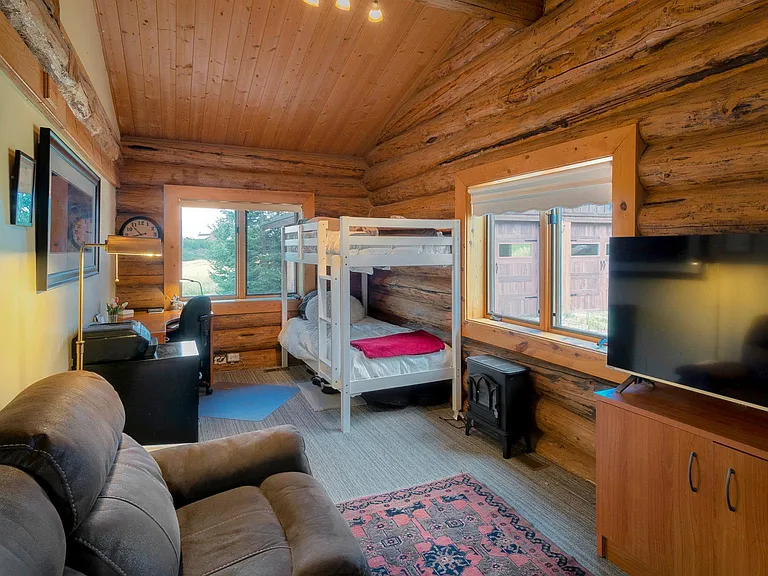 main level bedroom (3rd) with office desk and tv