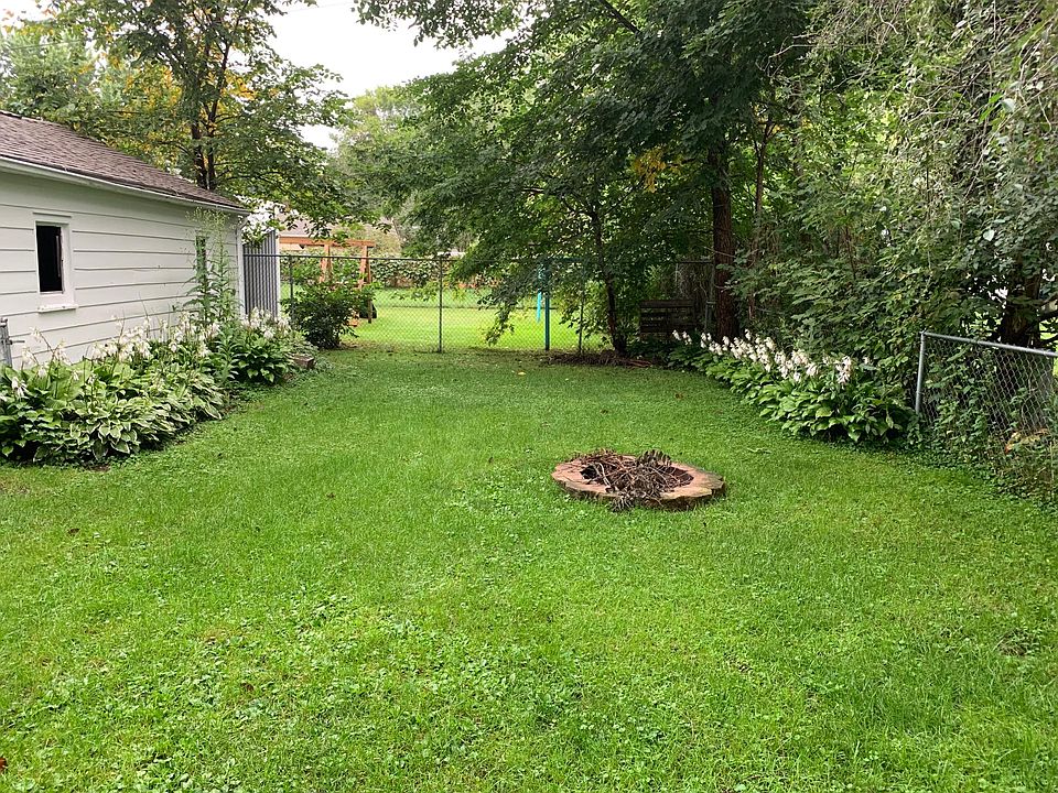 Fenced in backyard w/ firepit