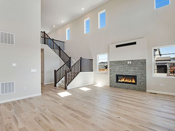 An open great room featuring a fireplace the perfect space for entertaining guests