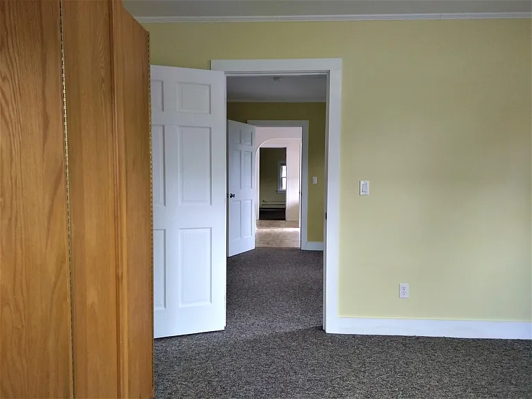 Front bedroom looking towards living room, kitchen eat-in area and rear bedroom. Bathroom is on left before the rear bedroom.