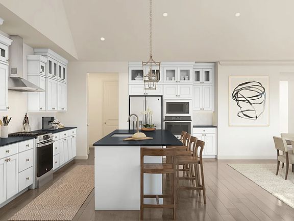 Pendant lighting and gorgeous countertops in kitchen
