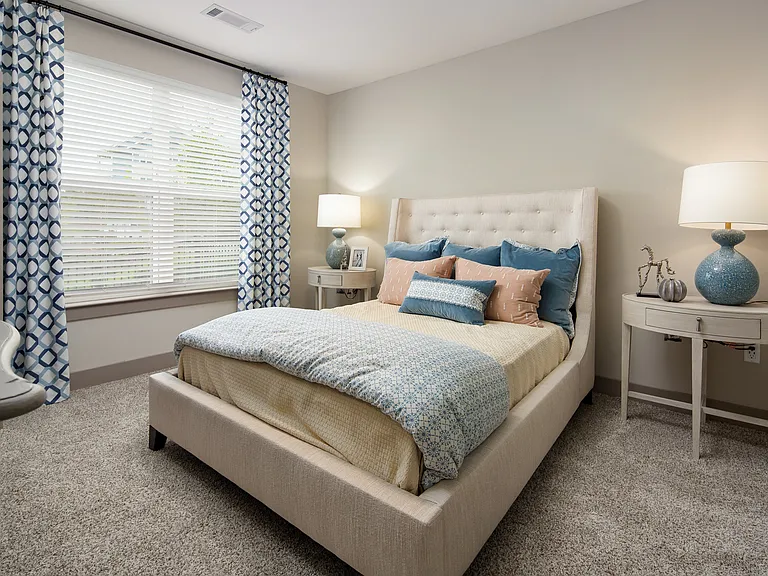 Bedroom with a window and carpeted flooring