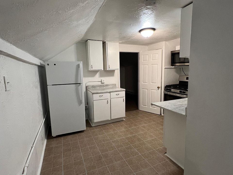 Kitchen with new countertops, gas stove and microwave