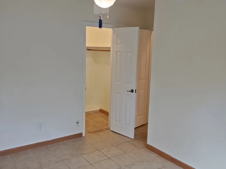 Middle Bedroom with walk in closet door open.