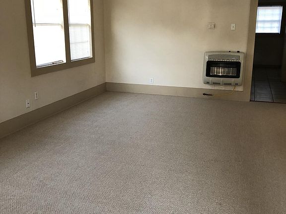 Living room is spacious and has NEW carpet