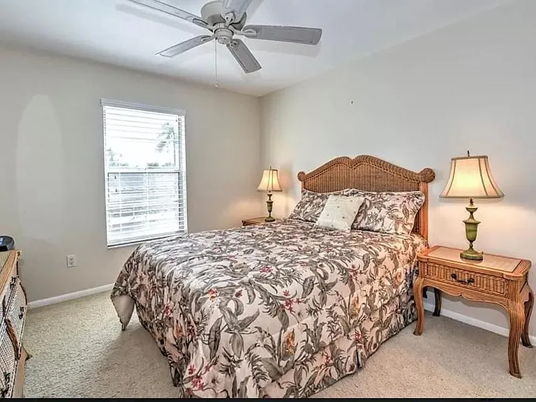 Guest bedroom with queen sized bed, tv, ceiling fan, ample closet space