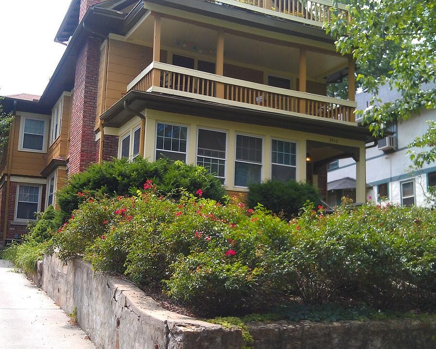 Street view of property. 2nd floor apartment with covered porch.