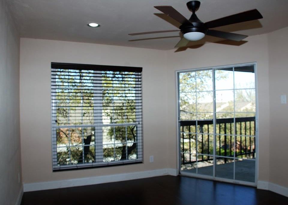 Bright living area opens to a balcony viewing trees