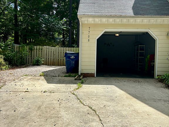 One car garage attached along with extra parking space alongside. Driveway can fit an extra 2 cars. 
4 cars total can fit.