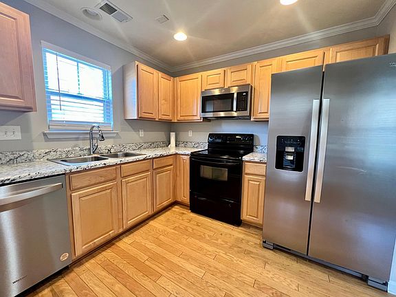 The kitchen has brand-new stainless steel appliances. After the current tenant moves out on March 1st, the downstairs will be refreshed with new flooring, updated backsplash, and painted cabinets. The home will be professionally cleaned before move-in.
