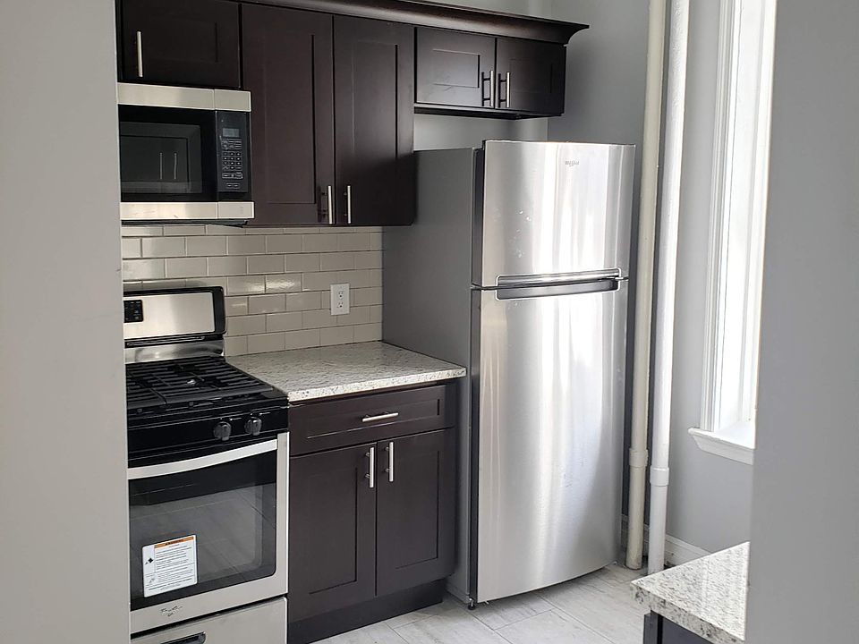 Renovated kitchen with a modern tile floor. Stainless Steel appliances. Granite countertops.
