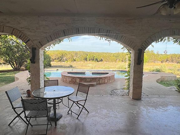 Love this huge covered patio overlooking the pool, spa and surrounding hill country!
