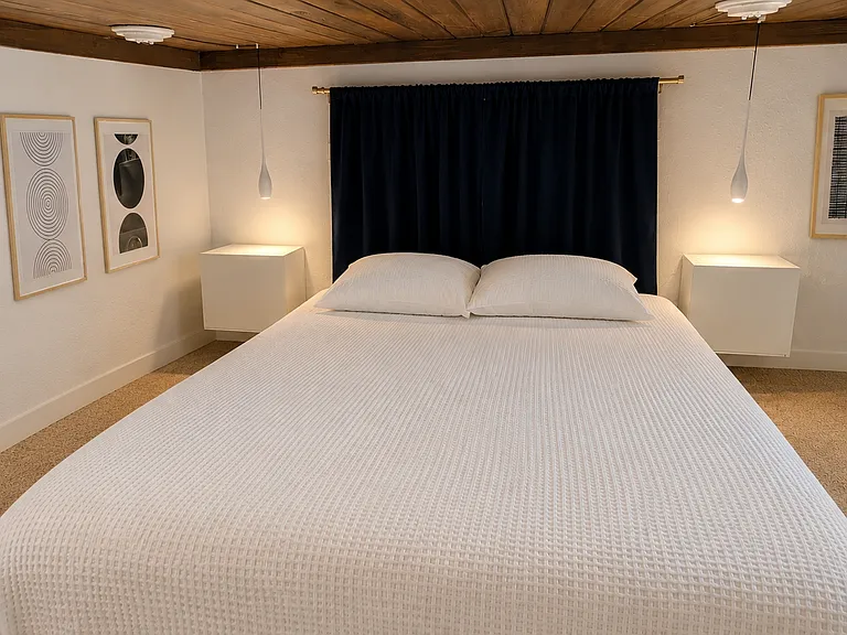 Recharge in a king-size bed with blackout curtains for restful mornings, even after overnight shifts.