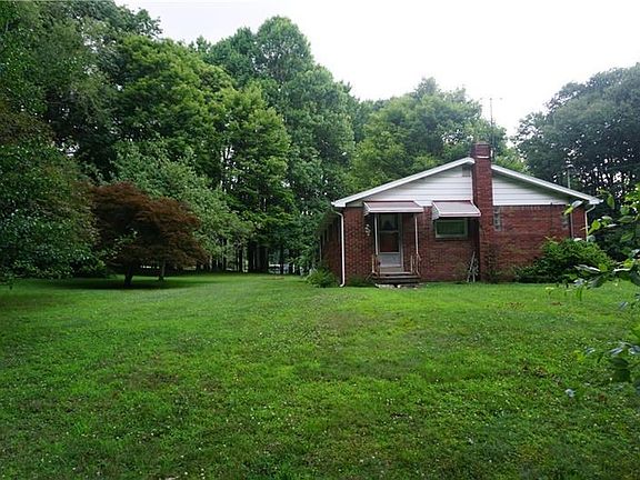 Side view of home showing door to kitchen and how private the setting of the back yard is.
