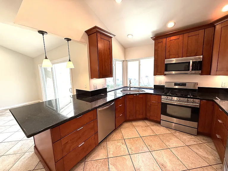 Kitchen showing penisula with counter that can be used for seating.