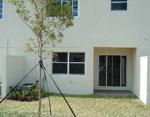 Back yard with sliding glass doors facing lake