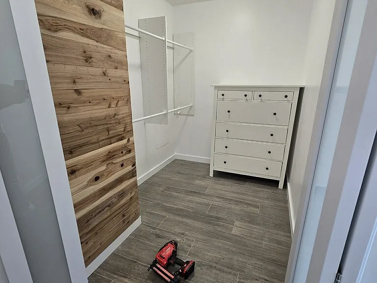 walk in closet with cedar accent wall