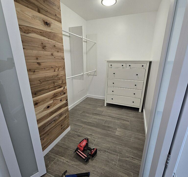 walk in closet with cedar accent wall