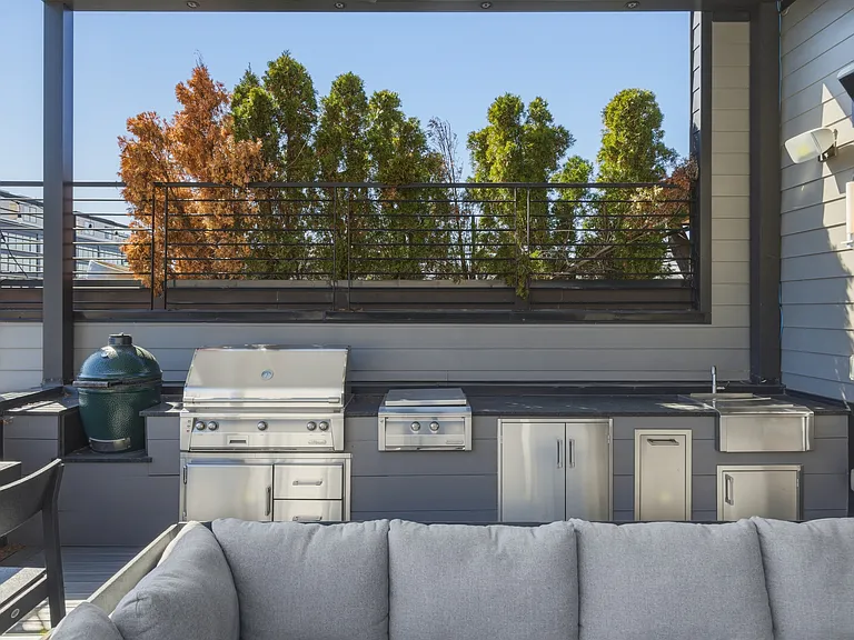 Spacious rooftop patio with a cozy fireplace, BBQ grill, outdoor TV, retractable Nano wall, adjustable louvered roof, LED lighting, wall heaters and plenty of lounge and dining seating_perfect for relaxing evening under the Nashville sky.
