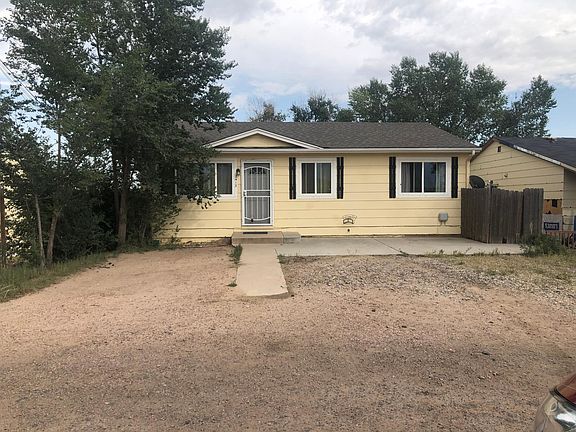 Front of house facing west with Pikes Peak views and lots of parking