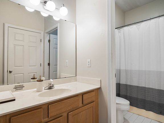 Master bathroom and vanity. Just across from the vanity is the laundry, you can see the door in the vanity mirror.