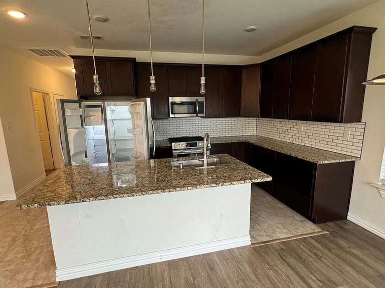 Kitchen and all appliances, refrigerator, dishwasher, trash drawer, microwave and gas stove.