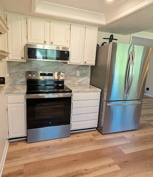 Kitchen: brand new electric range and newer refrigerator.