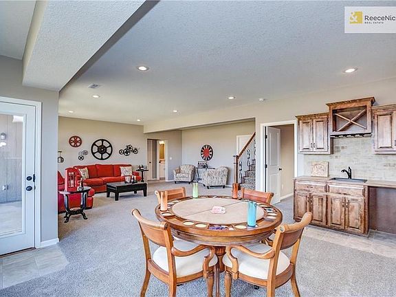 simulated photo: shows lower level family room with wet bar. Lower level has one more bedroom and one more bathroom as well as tons of unfinished storage space! This simulated photo shows a walkout door: This Villa home does NOT have a walkout door.