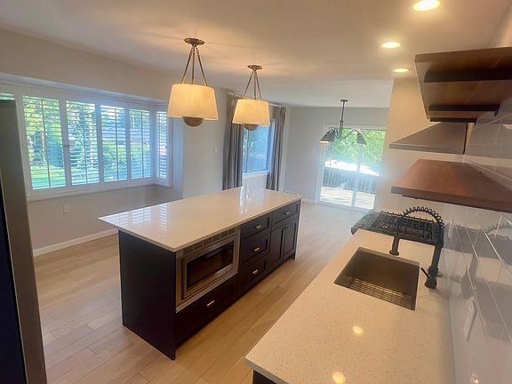 Kitchen from foyer angle, looks out to backyard.