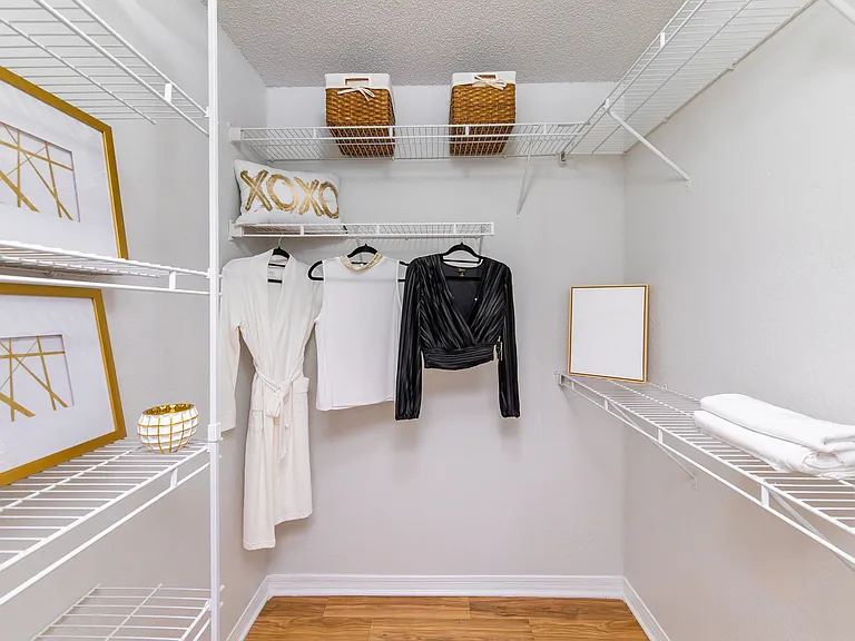 Stay effortlessly organized with this stylish walk-in closet, featuring built-in shelving and plenty of space to organize your wardrobe.