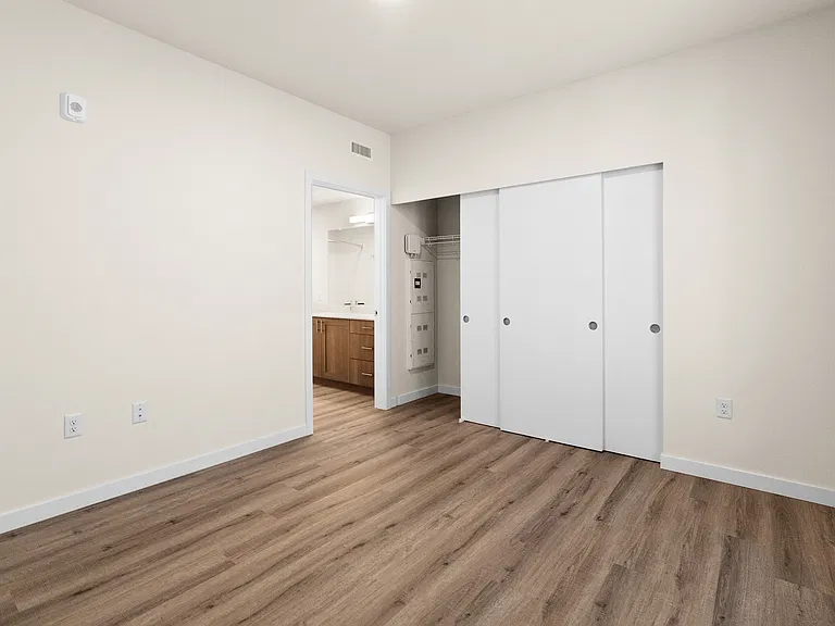 Spacious bedroom with large closet and en-suite bathroom access. Spacious bedroom with large closet and en-suite bathroom access.