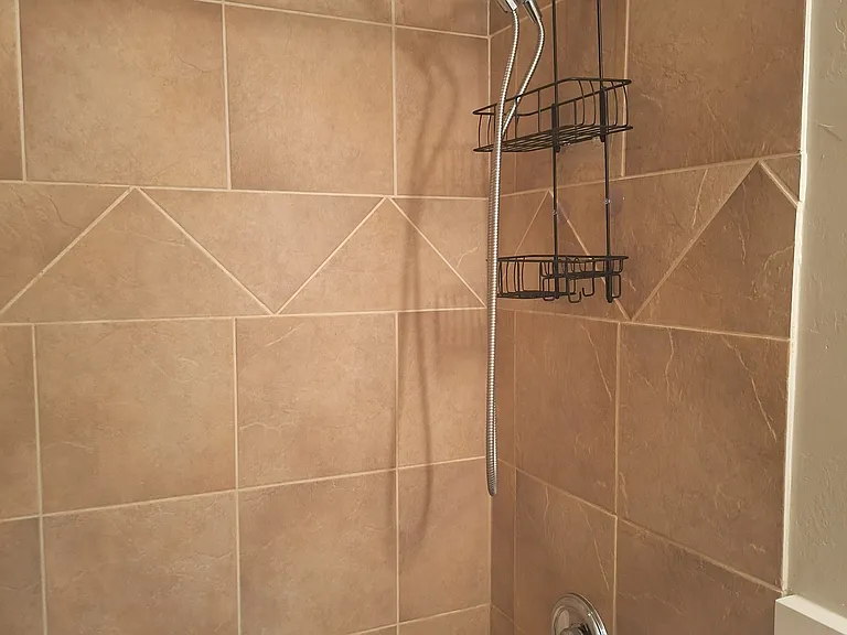 Full tub and shower in middle bathroom.