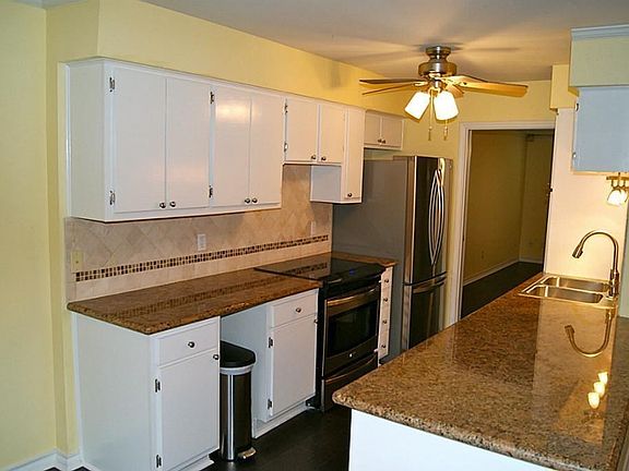 Kitchen boasts granite countertops, stainless steel appliances including "french door" refrigerator.