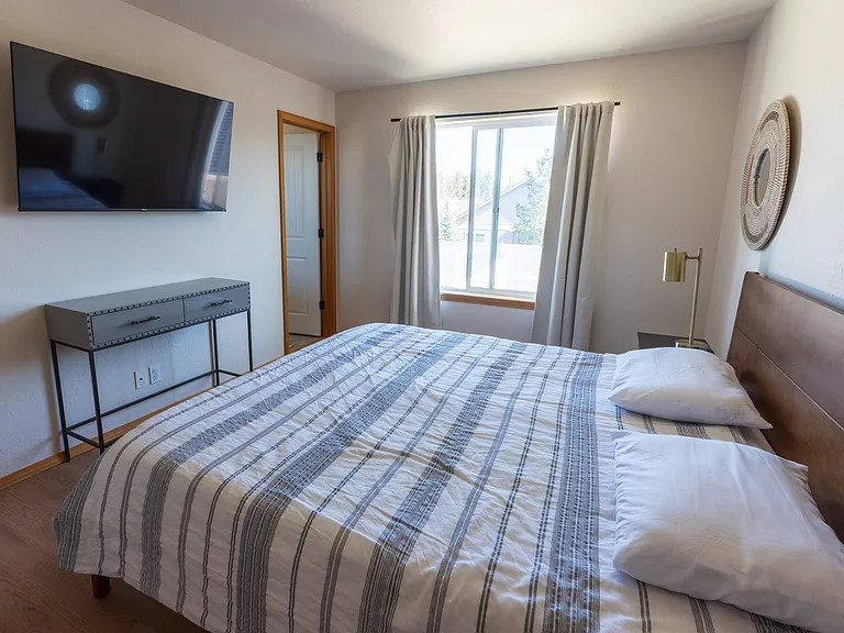 Main Bedroom - Spacious Walk in Closet with window. New KING memory foam mattress in 2026. View of Canfield Mountain.