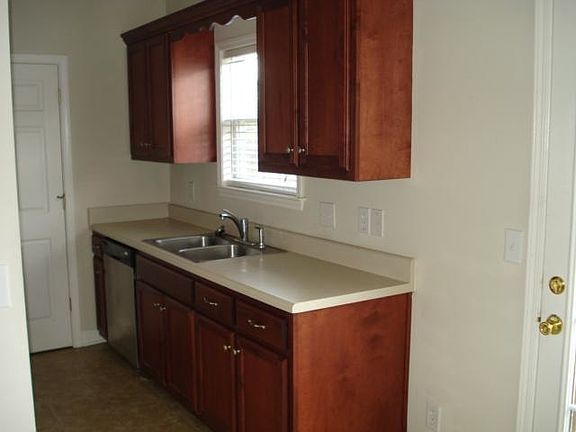 galley style kitchen with stainless appliances. washer and d