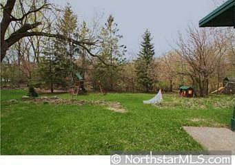 Large back yard with mature trees bordering lot and Pamela Park