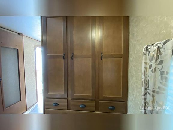 Triple hanging wardrobe with 4 drawers, full length on side.
