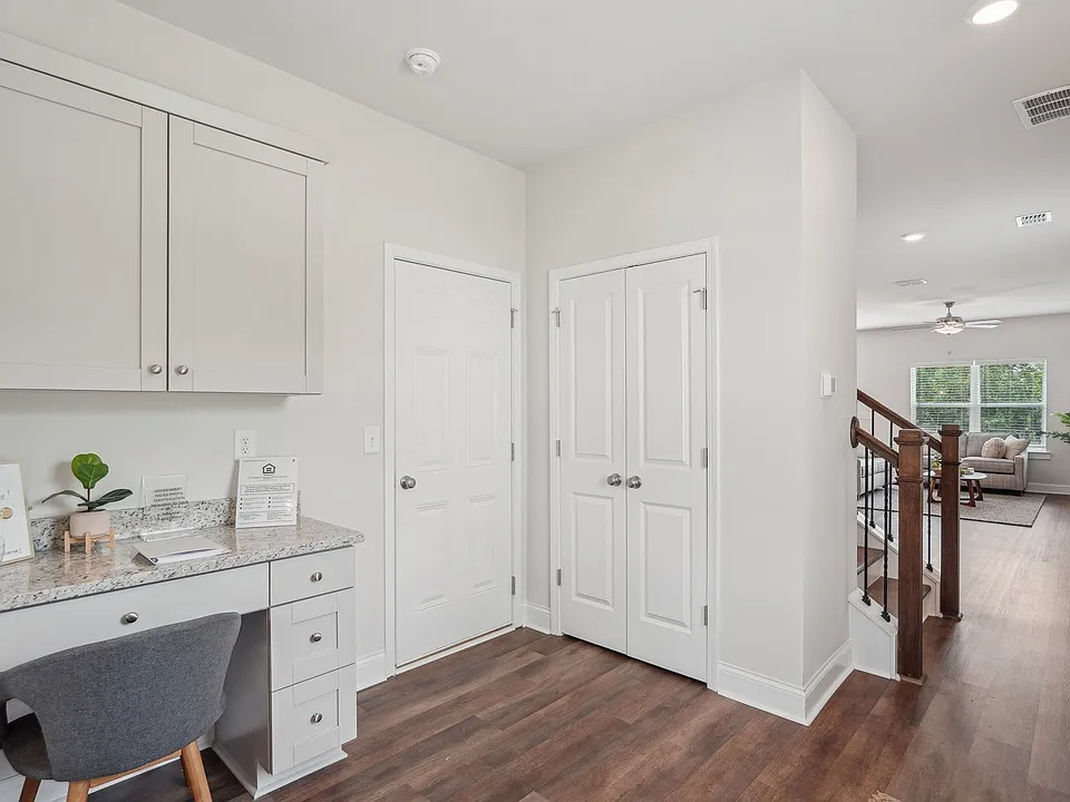 The entrance to the Aberdeen home featuring rich hardwood-style flooring and crisp white walls.