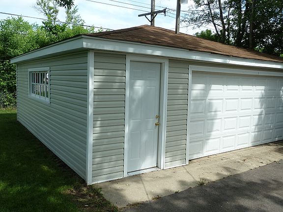 Large 2 1/2 car garage with work bench and storage