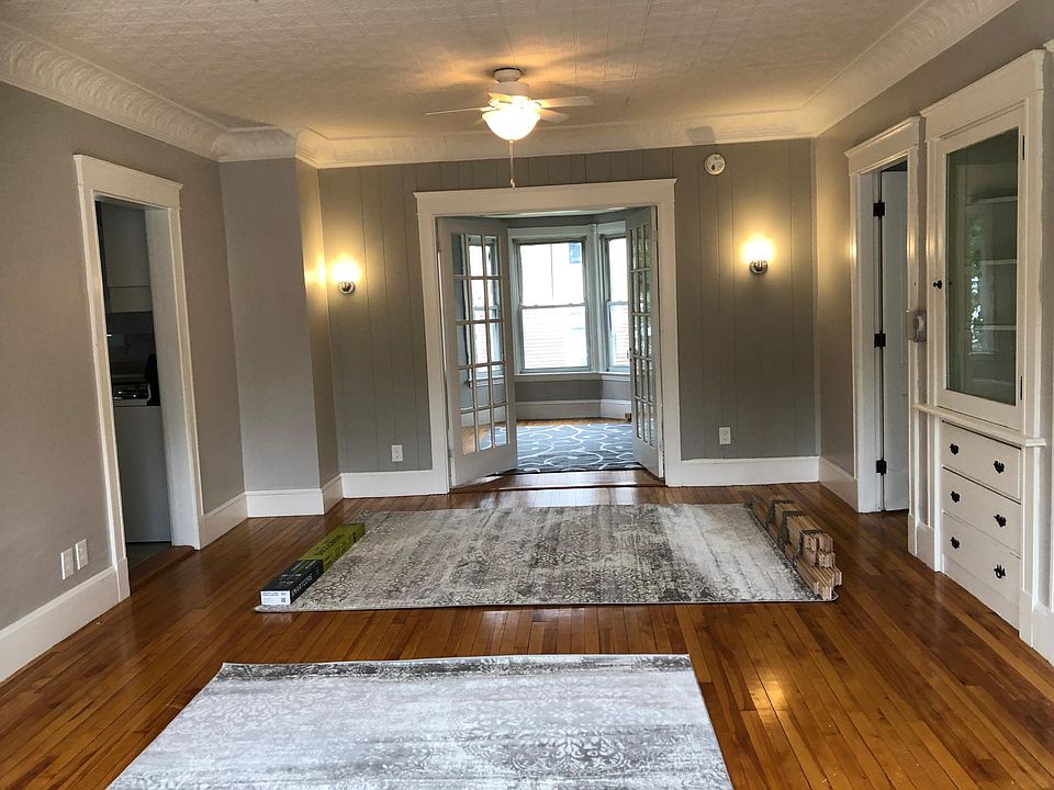 Huge living room with beautiful ceiling and 2 original built in hutches.