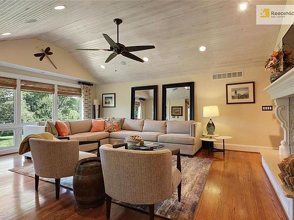 Living room with vaulted ceilings, surround sound, and fireplace.