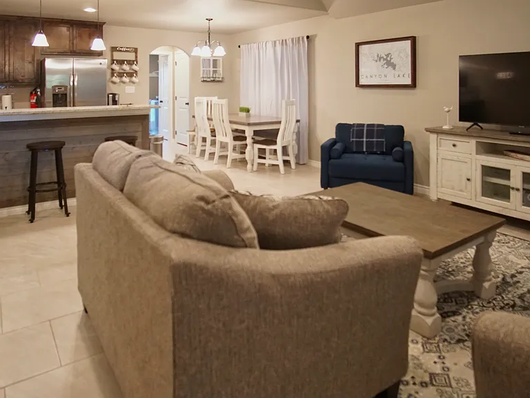 Comfortable open-concept living room flowing seamlessly into the dining area and kitchen.