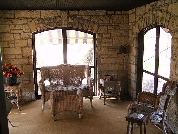 Character filled stone room with archways viewing grounds off great room.