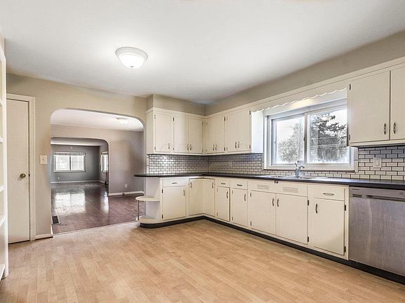 View of kitchen showing the dining room and into the family room.