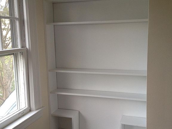 Living room (w/ built in bookshelves, showing 2nd of 2) Size: 9.75 x 19'