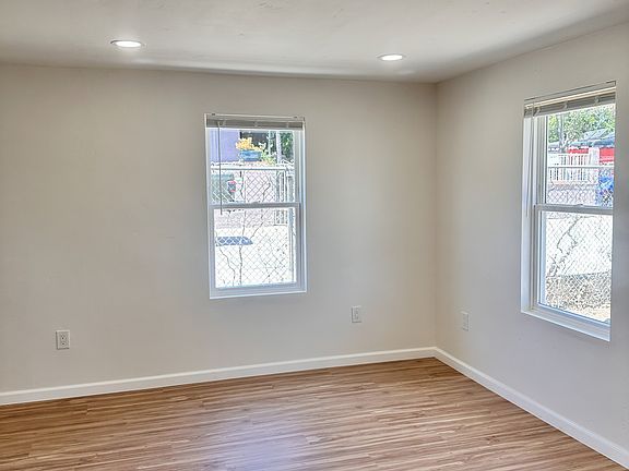 View of living room. New flooring, lighting, paint, and windows