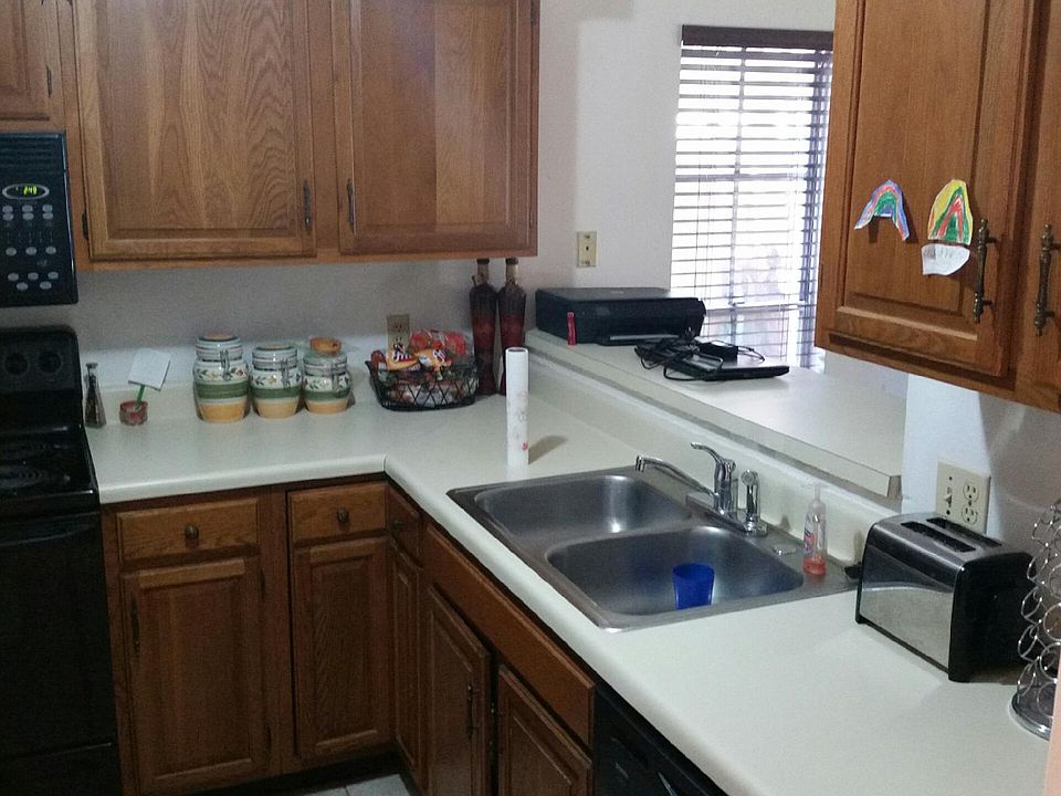 kitchen with oak cabinets and black appliances