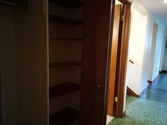Full hallway closet in between the bathroom and 2nd bedroom. One side of closet is for hanging clothes, and the other side is several shelves.