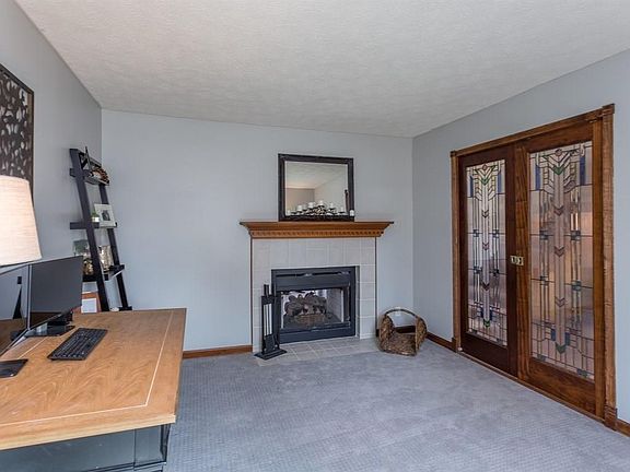 This main level office/den features a double sided fireplace.