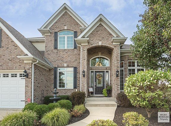 Grand covered front entrance~Lovely manicured landscape & fresh mulch!